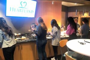 Event guests in buffet line in skybox at Heartland Dental event, Charlotte Hornets v Chicago Bulls, 1/26/2023