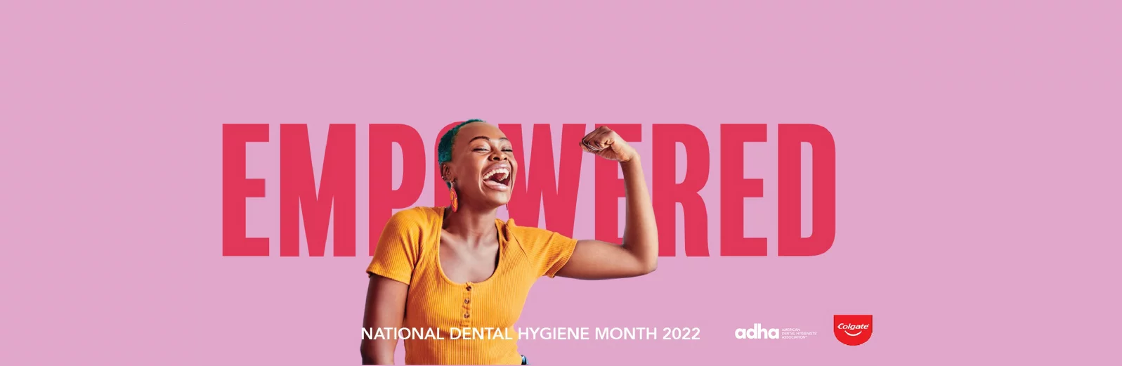 Empowered. Woman flexing her left arm and smiling.