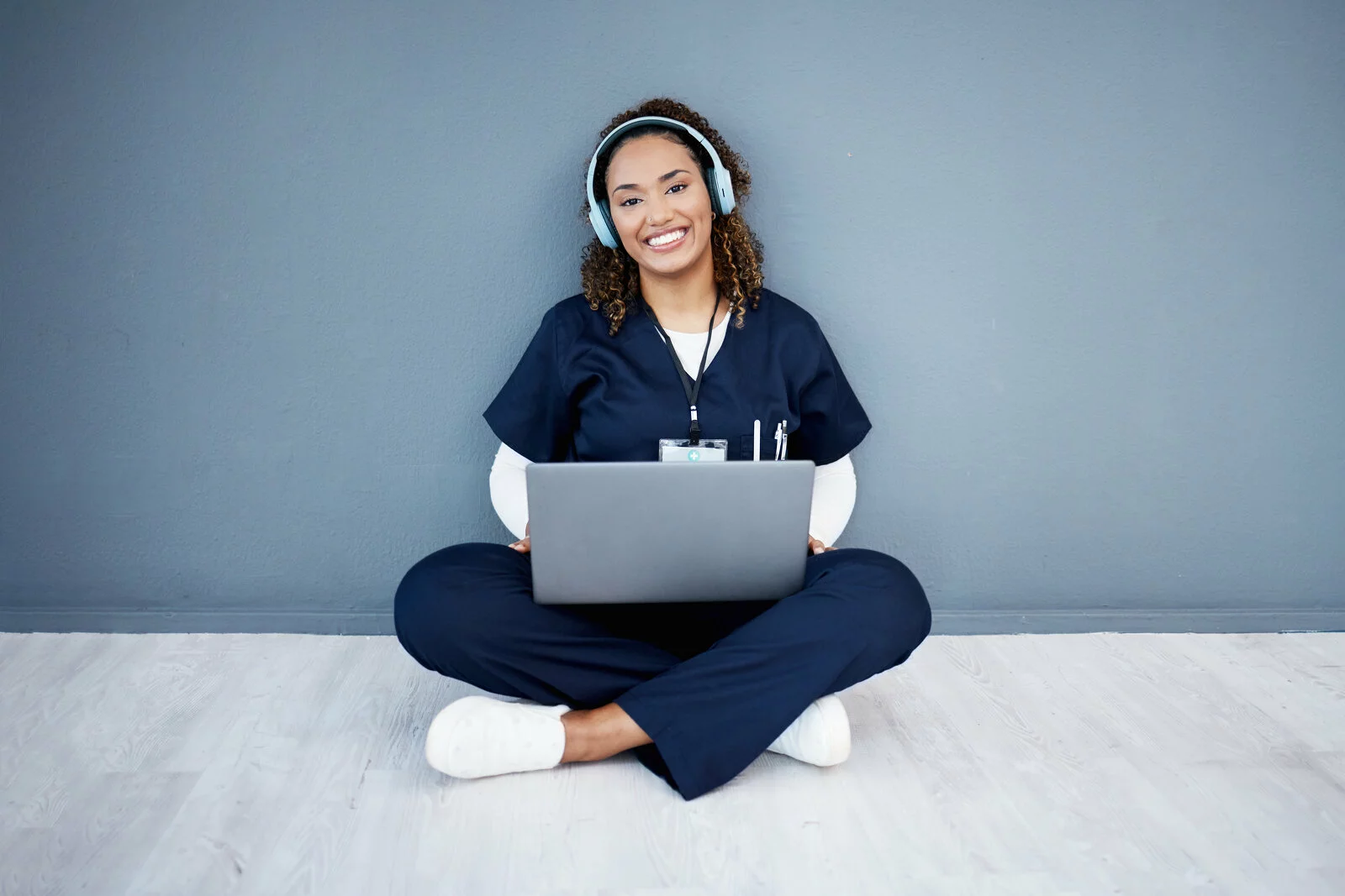 Portrait, laptop or headphones of hospital music, podcast or radio in woman study research or mock up nurse learning. Smile, happy or medical student on technology and listening to healthcare audio 2023/12/iStock-1482827000-1.jpg 