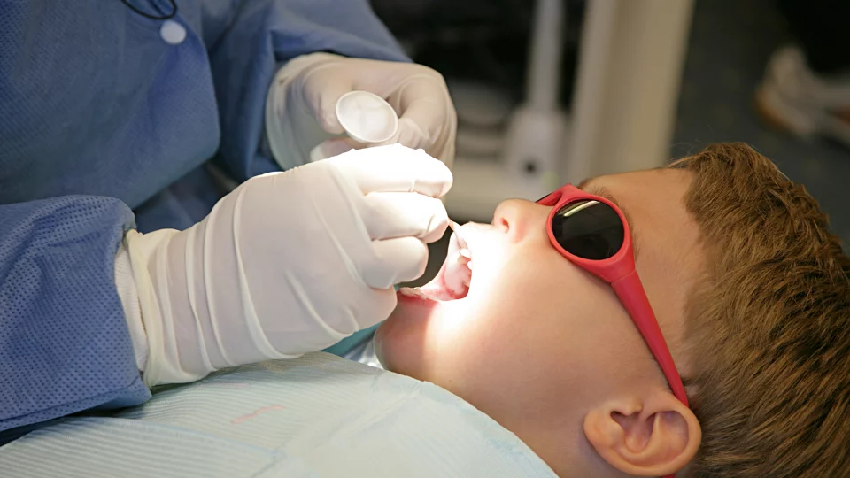 Applying Fluoride to Child's Teeth