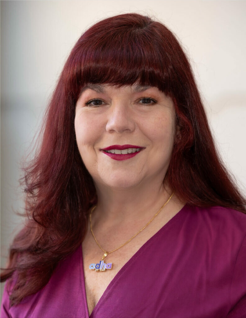 Headshot of Becky Smith smiling wearing ADHA logo pendant.