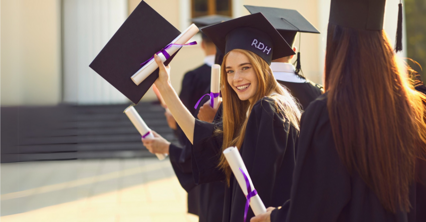Graduates holding their diplomas