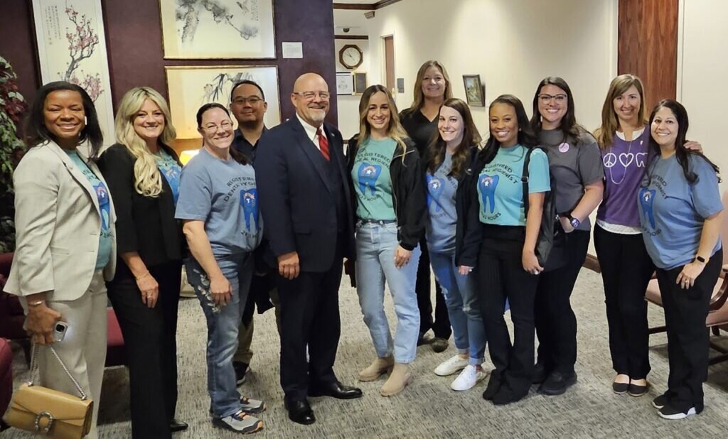 A group of dental hygienists pose with Senator Ira Hansen of Nevada at the Legislative Building in Carson City.