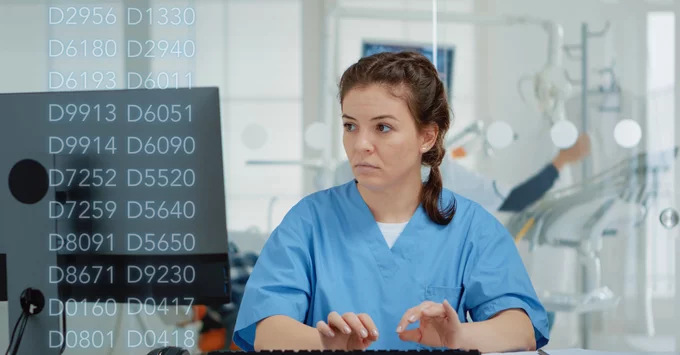 Dental hygienist at computer with Dental Codes on image