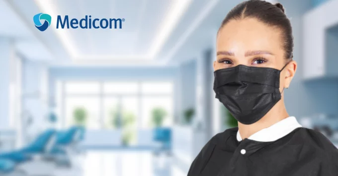 Female hygienist in black Medicom PPE mask.