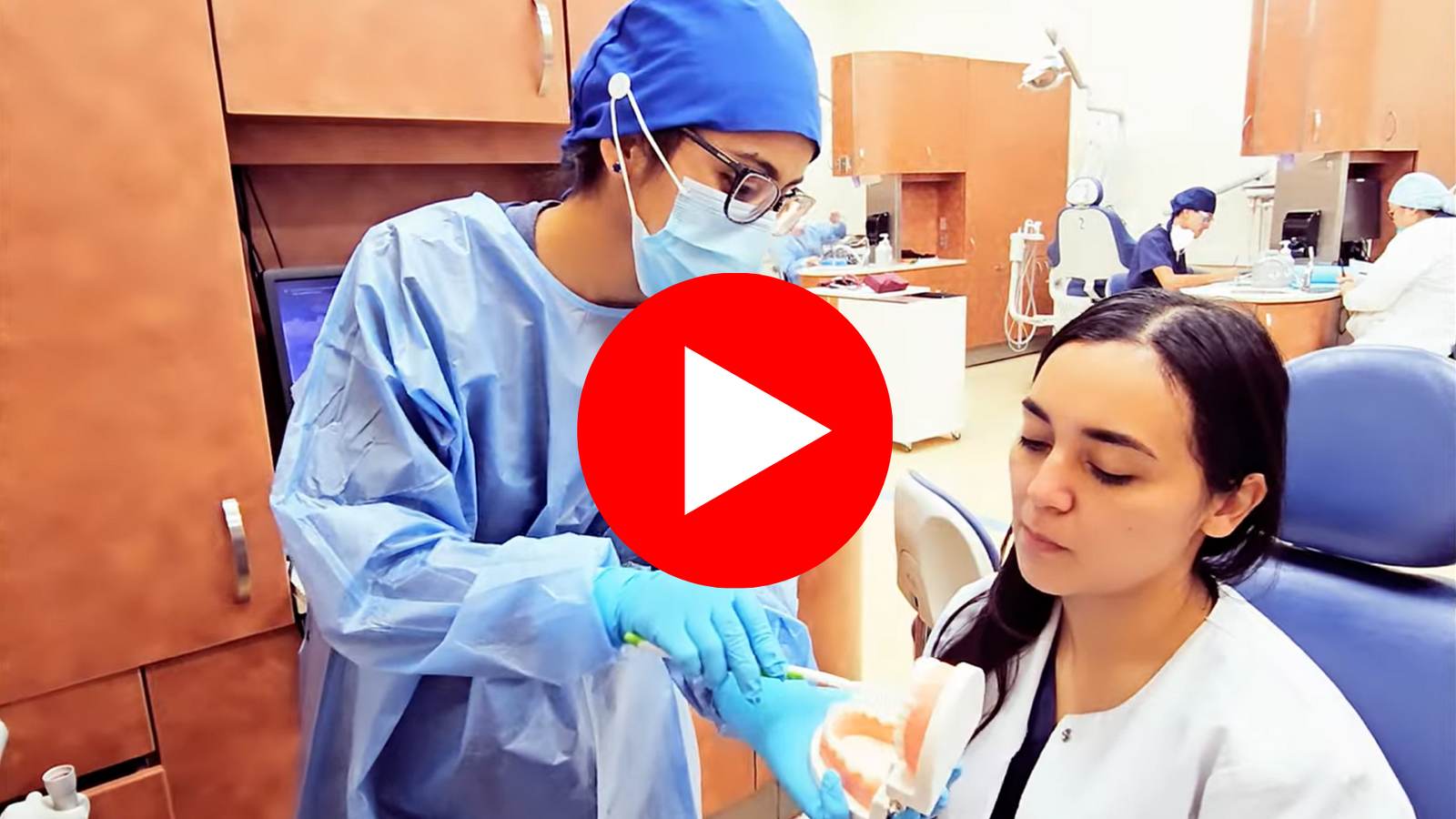 A dental hygiene student demonstrated proper brushing technique to a patient in the school clinic.