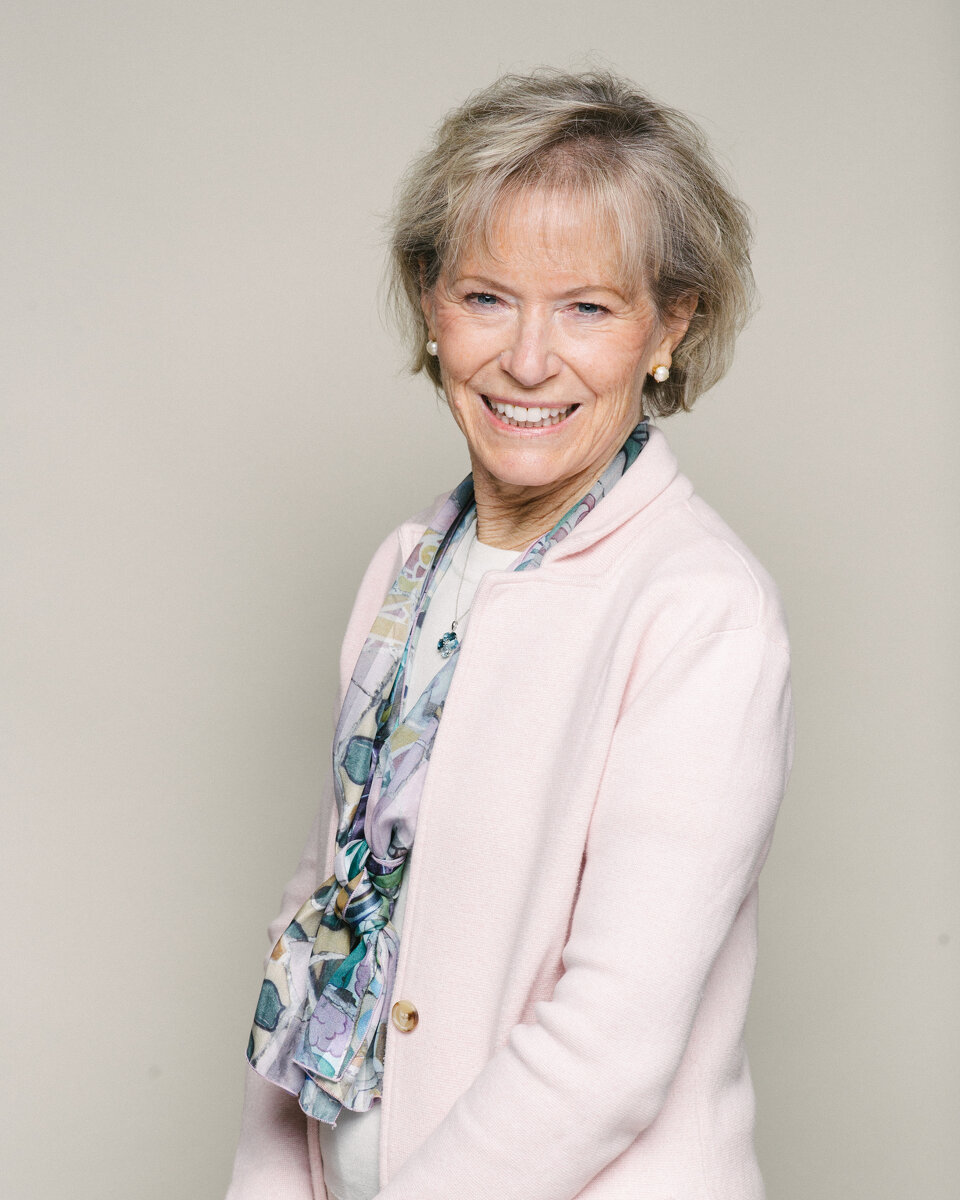 Cathy Draper half body portrait photo in light pink suit