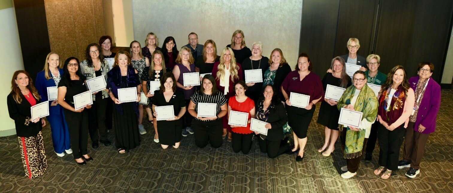 A group of dental hygienists pose with their certificates