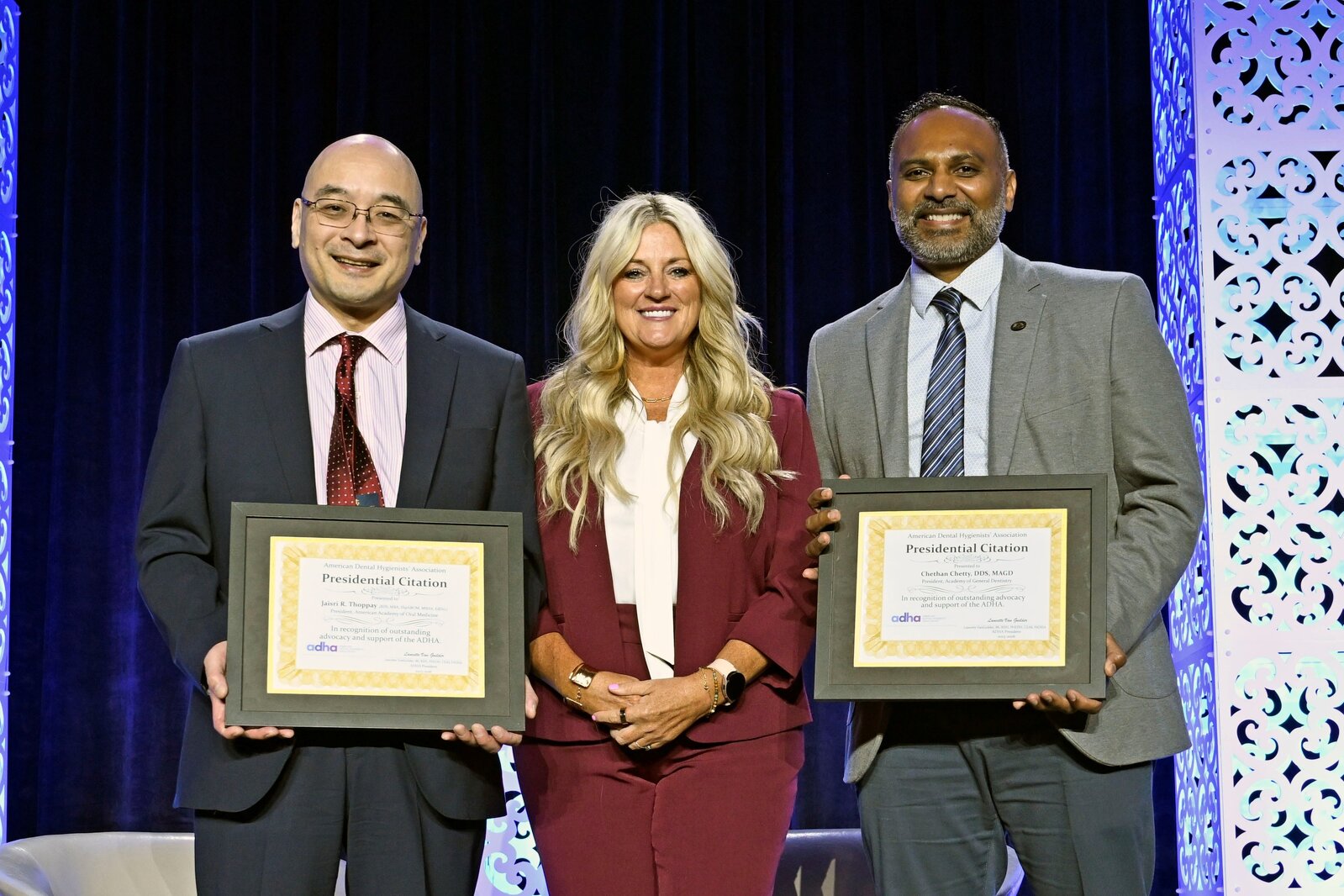 Lancette stands in the center with Dr. Ikeda on the left and Dr. Chetty on the right.