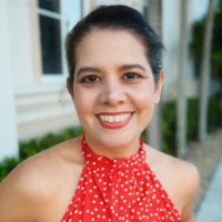 Andreina Sucre Beltran, CRDH, International dentist, MSc in red dress with white polka dots.
