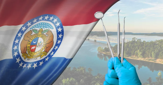 Missouri Flag on a landscape background with a gloved hand holding scalers and a dental mirror