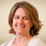 Jerelyn Smith smiling with beige sweater and necklace