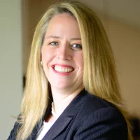 Lisa Mayo, RDH, BSDH, MHA, in blue jacket with white top