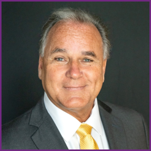 George Schmidt, DMD, FAGD, FICOI headshot in grey jacket and gold tie