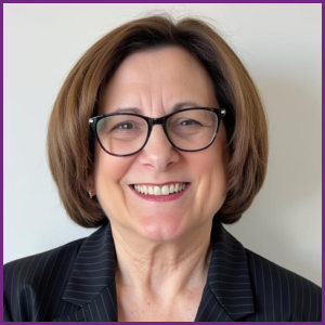 JoAnn Gurenlian headshot with glasses, black jacket, smiling
