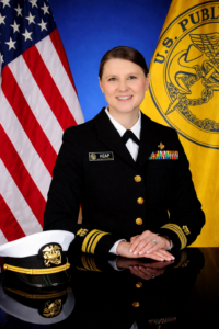 LCDR Erin Heap- USPHS officer portrait w. flags (1)