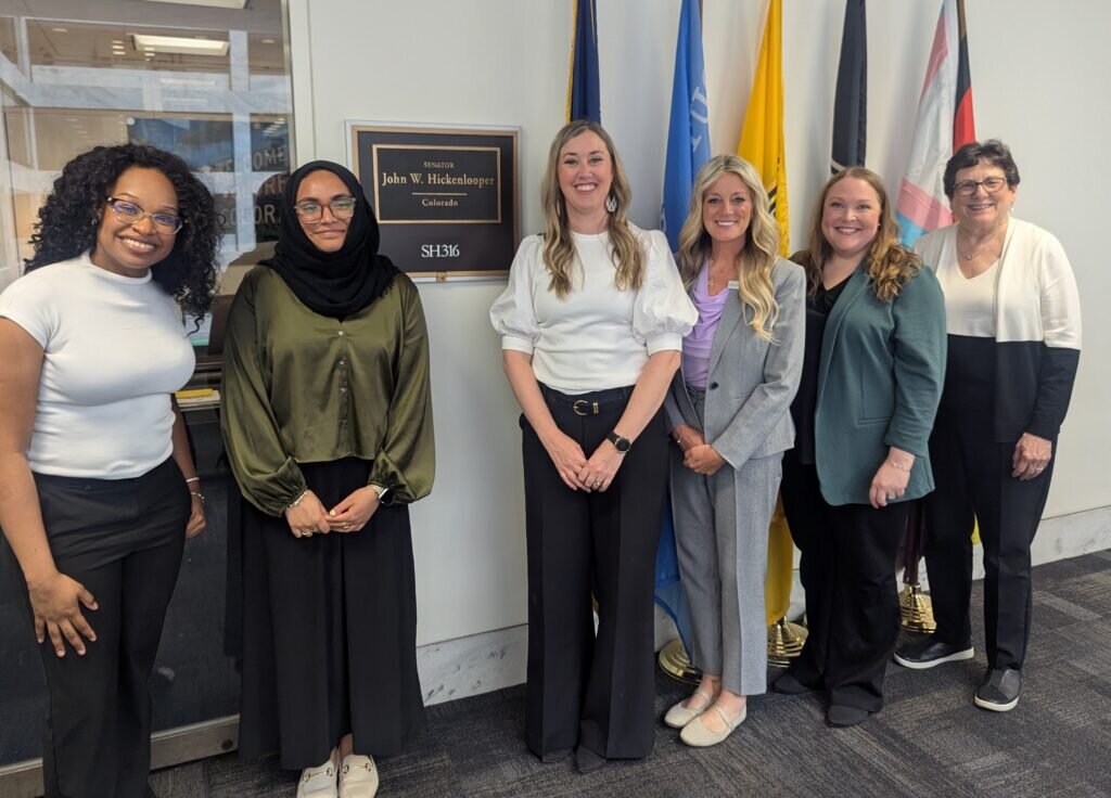 5 ADHA representatives post outside of a congressional office with a congressional staffer