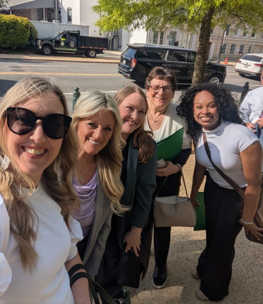 Group smiling into camera including Alyssa Aberle, Lancette VanGuilder, Jessica August, JoAnn Gurenlian and Katherine Williamson