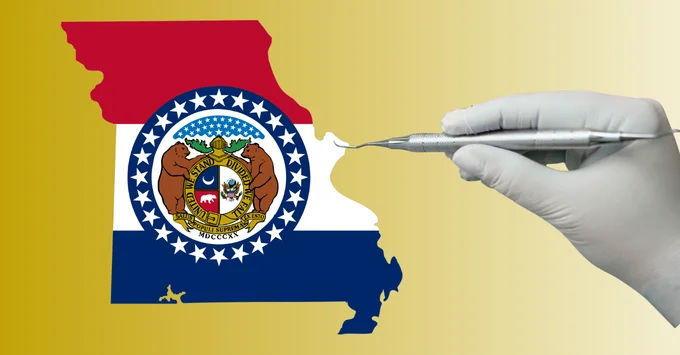 Gloved hand holding a scaler over the Missouri flag in the shape of the state outline