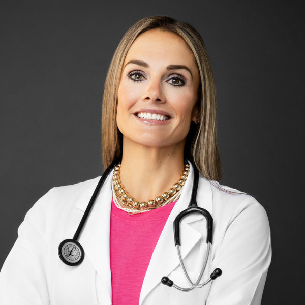 Headshot of Lauren Shannon, Nurse Practitioner in a pink top and white coat with stethoscope